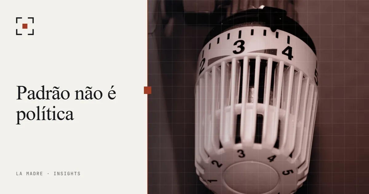Um termostato de radiador ajustado no meio da escala, em duotone La Madre, ao lado das palavras Padrão não é política