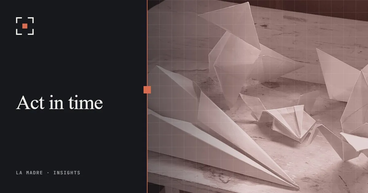 White paper airplanes and origami birds on a wooden table, in La Madre duotone, beside the words Act in time