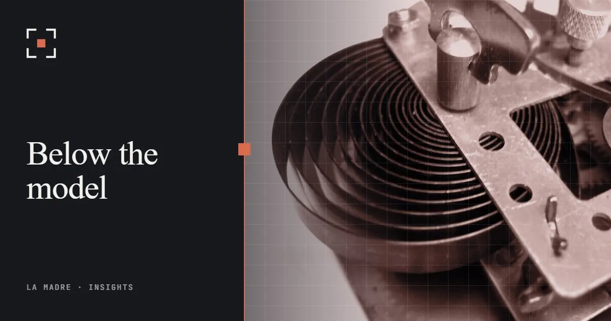 The coiled mainspring and plates inside an alarm clock, in La Madre duotone, beside the words Below the model