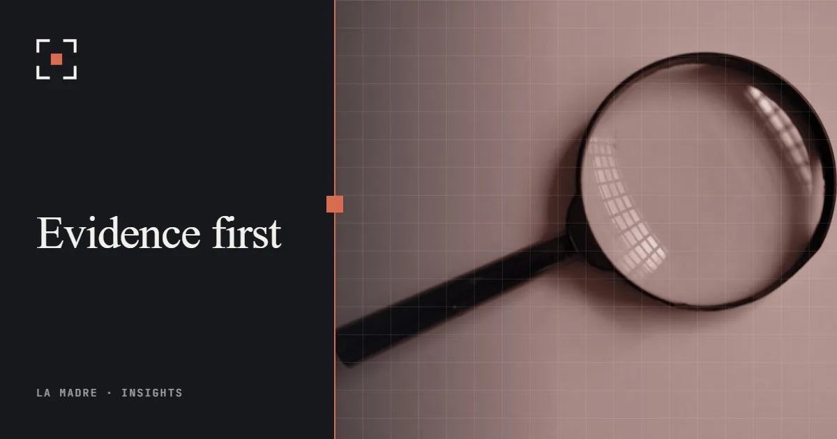 A magnifying glass resting on a pale surface, in La Madre duotone, beside the words Evidence first