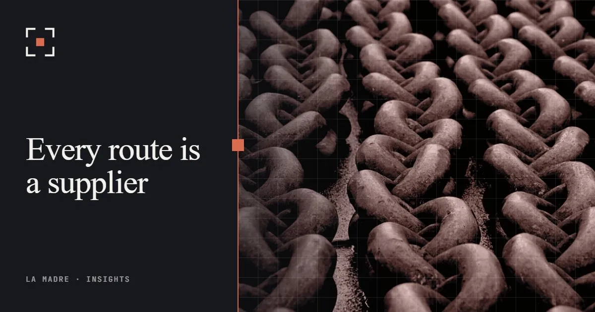 Heavy rusted chain links piled together, in La Madre duotone, beside the words Every route is a supplier