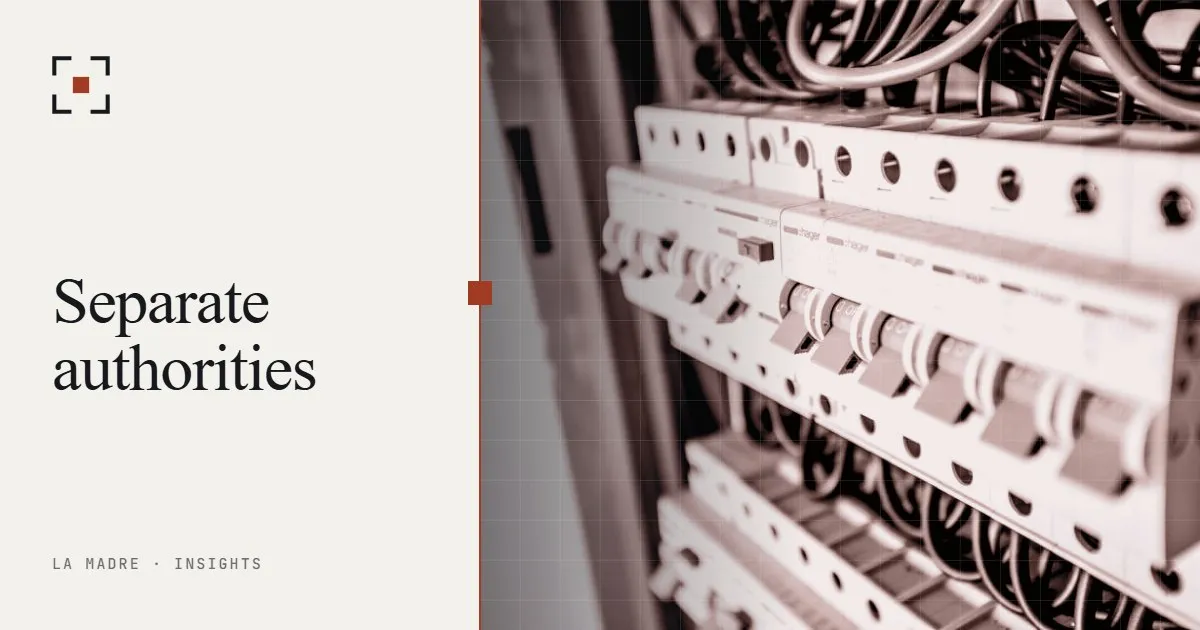 A row of circuit breakers in an electrical panel, in La Madre duotone, beside the words Separate authorities