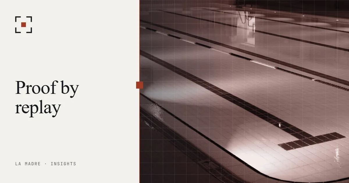 Empty parallel lanes of an indoor swimming pool, in La Madre duotone, beside the words Proof by replay
