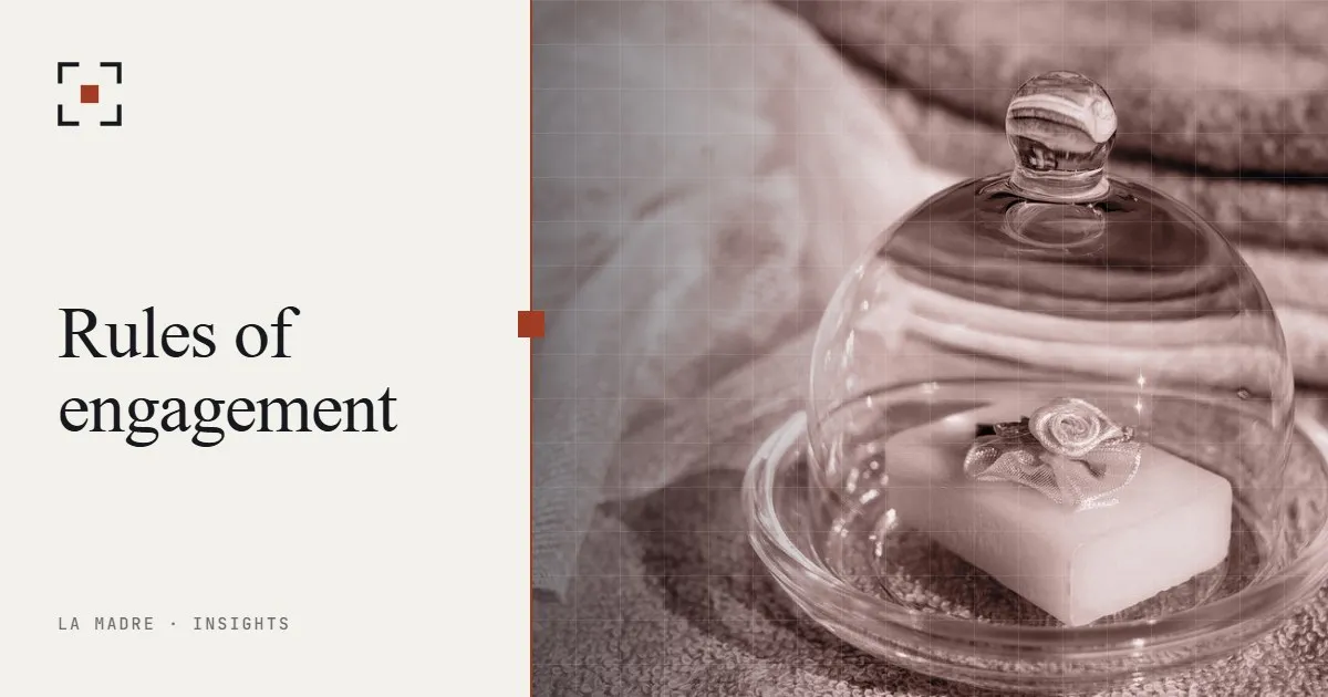 A small object sealed under a glass cloche, in La Madre duotone, beside the words Rules of engagement