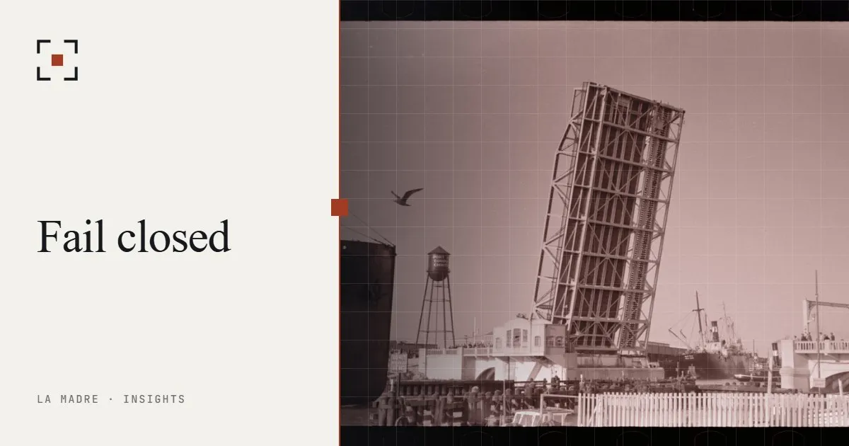 A raised drawbridge at a port, with a ship waiting beside it, in La Madre duotone, beside the words Fail closed