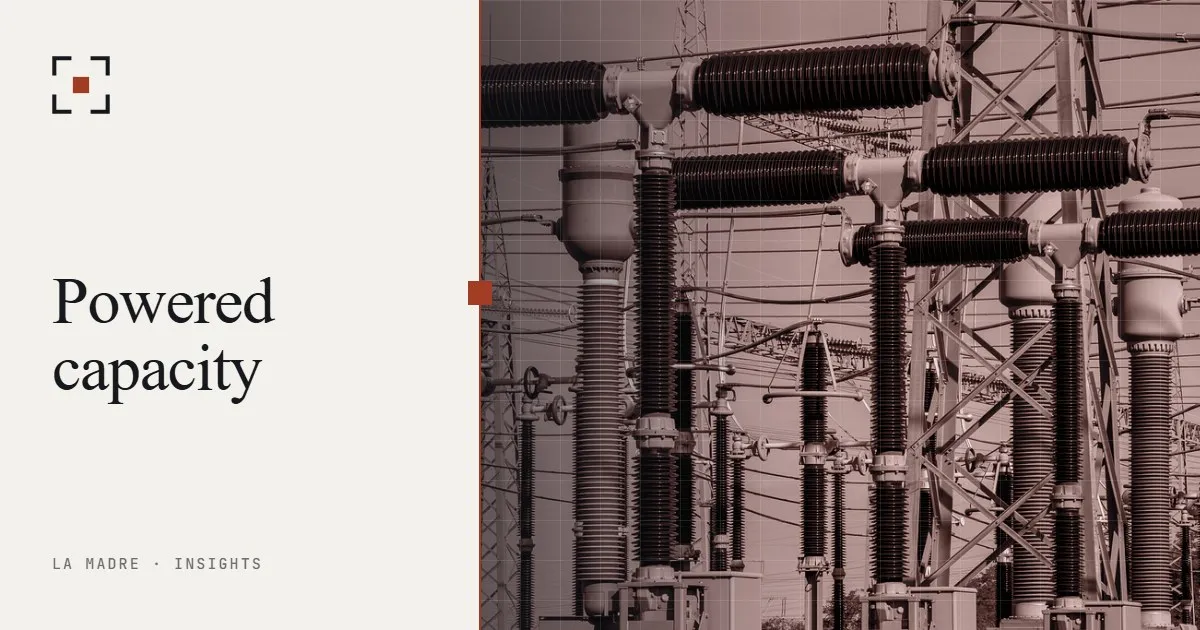 Insulators and conductors at an electrical substation, in La Madre duotone, beside the words Powered capacity